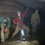 “Sherpas” are the backbone of the expedition and haul the gear to and from the sump. Here Steph Petri, lead sherpa in charge of gear haul provides some comic relief in the mud of the Logsdon River.