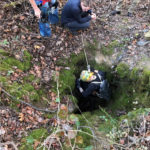 Steph Petri is the first one to rappel down into a new pit she discovered while on the surface locate.